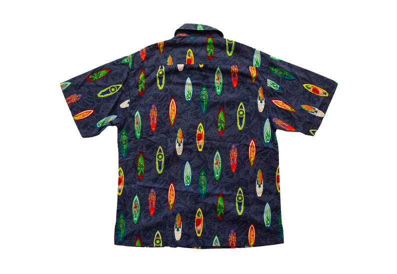 May include: Dark blue short-sleeved button-down shirt with a pattern of colorful surfboards. The surfboards are in various colors, including red, yellow, green, and white. The shirt has a classic collar and is made of a lightweight fabric.
