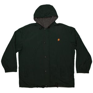 May include: A dark green hooded jacket with a gray interior lining. The jacket has a button-up front, long sleeves, and a drawstring at the bottom. An orange emblem is on the left chest.