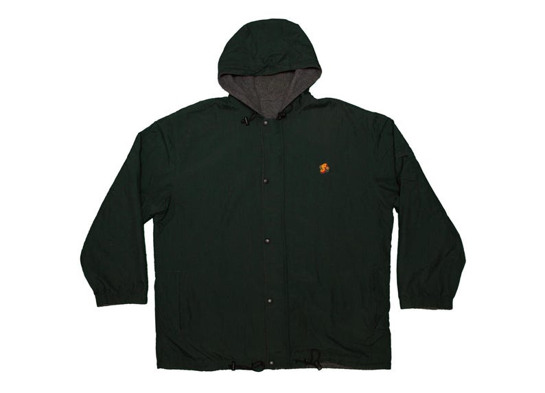May include: A dark green hooded jacket with a gray interior lining. The jacket has a button-up front, long sleeves, and a drawstring at the bottom. An orange emblem is on the left chest.