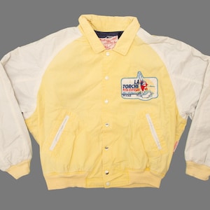 May include: A yellow and white baseball jacket with a La Torche embroidered patch on the front. The patch features a red and blue design with a skier and the text "La Torche Ski Club".