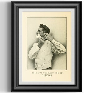 May include: Framed vintage print depicting a man shaving his face with a straight razor. The black and white image shows the man in a white vest and shirt, with the text "TO SHAVE THE LEFT SIDE OF THE FACE" at the bottom.