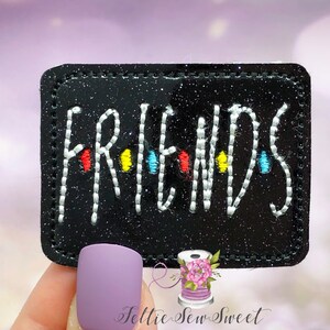May include: Black glitter fabric patch with white embroidered text "FRIENDS" and colorful dots.