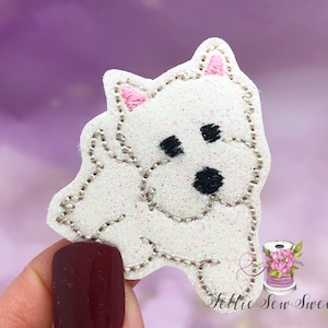 May include: White glitter iron-on patch of a white West Highland Terrier dog with pink ears and black eyes.