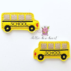 May include: Two yellow school bus iron-on patches with black outlines and the word "SCHOOL" in black lettering.