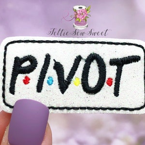 May include: White rectangular patch with the word "PIVOT" embroidered in black thread. The letters have colorful accents: red, blue, and yellow. The patch is outlined with black stitching.