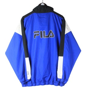 May include: A blue, black, and white Fila windbreaker jacket with a white Fila logo on the back.