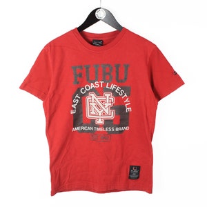 May include: Red short-sleeved t-shirt with a black and white graphic print that says "Fubu East Coast Lifestyle American Timeless Brand".