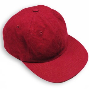 May include: A solid red baseball cap with a curved brim.