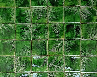 May include: A green tiled wall with a fern pattern. The tiles are arranged in a grid pattern.
