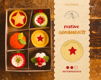 May include: A box of handmade festive ornaments. The ornaments include a star, a green ball, an orange, a pie with a star, a red ball, and a chocolate pie with holly. The text on the right says "Tutorial" and "Festive Ornaments".