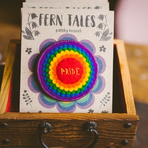 Rainbow felt badges that have the word Pride embroidered