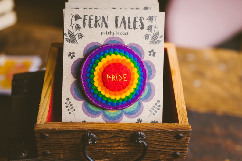 Rainbow felt badges that have the word Pride embroidered