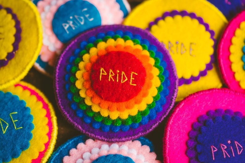 Rainbow felt badges that have the word Pride embroidered