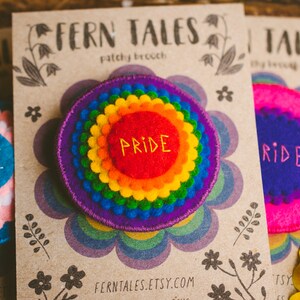 Rainbow felt badges that have the word Pride embroidered