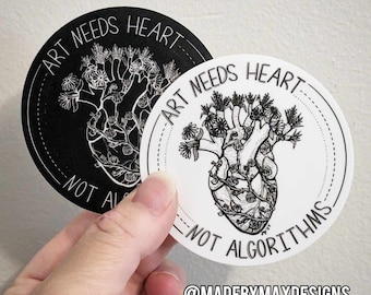 May include: Two black and white round stickers with a heart with flowers growing out of it. The text on the stickers reads "Art Needs Heart - Not Algorithms" and "@MadeByMaxDesigns".