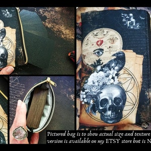 May include: A black zippered pouch with a skull and floral design. The pouch is made of fabric and has a gold zipper. The pouch is shown with a deck of cards.