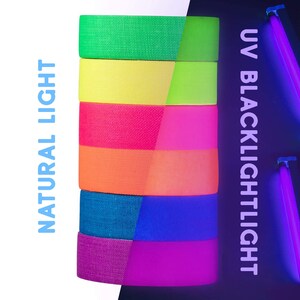 May include: A stack of six rolls of neon colored tape. The tape is shown under natural light and under a UV blacklight. The tape glows brightly under the blacklight. The colors are green, yellow, pink, orange, blue, and purple.