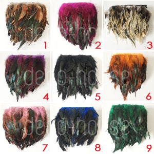 May include: Nine different feather trims in various colors, including black, brown, orange, pink, red, blue, and green. Each trim is approximately 10 inches long and features a variety of feather lengths.