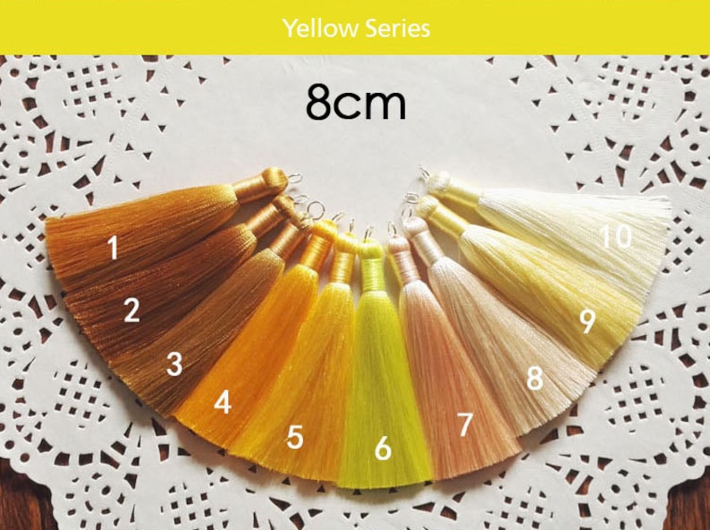May include: Ten 8cm long tassels in various shades of yellow, orange, and cream. The tassels are numbered 1 through 10. Yellow Series.