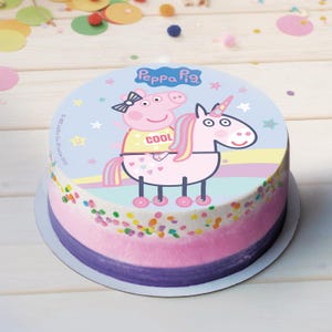 Könnte beinhalten: Ein Peppa Pig-Kuchen mit einem rosa Einhorn, auf dem Peppa Pig reitet. Der Kuchen ist mit bunten Streuseln und einem blauen Hintergrund mit Sternen verziert. Der Text "Peppa Pig" ist auf den Kuchen gedruckt.