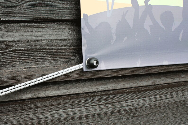 May include: A banner with a crowd silhouette, secured with a black grommet and white rope against a weathered wood background. The banner has a gradient of colors, with a yellow and orange sky.