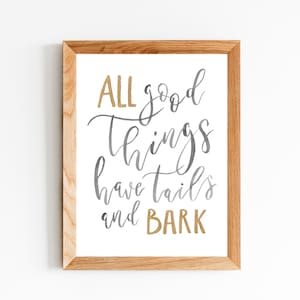 May include: A framed print with the text "ALL good things have tails and BARK" in gold and gray calligraphy.