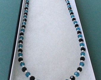 Teal and black crystal necklace with Sterling silver clasp and card gift box.