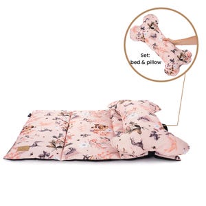 May include: A pink and white floral dog bed and pillow set. The bed is rectangular and the pillow is shaped like a bone. The set is made of soft, comfortable fabric and is perfect for dogs of all sizes.