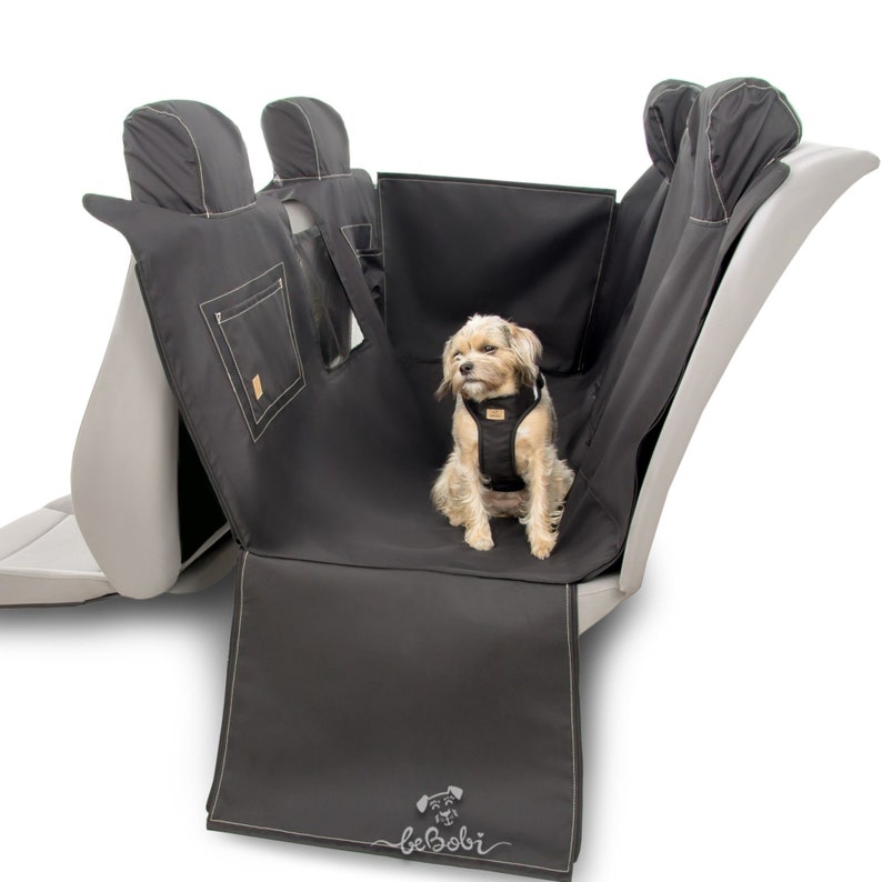 May include: Black car seat cover with a dog sitting in the back seat. The cover has a pocket on the back and the brand name "beBobi" is embroidered on the bottom.