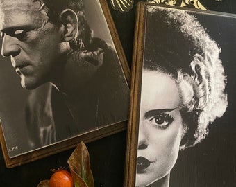 May include: Two black and white framed images of classic horror movie characters. The image on the left is of Frankenstein's monster, and the image on the right is of the Bride of Frankenstein.