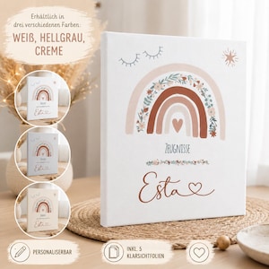 May include: A white rectangular canvas folder featuring a rainbow illustration with floral accents, a heart, and the text Zeugnisse and Esta. The design includes closed eyes and a star. The folder is available in white, light gray, and cream.