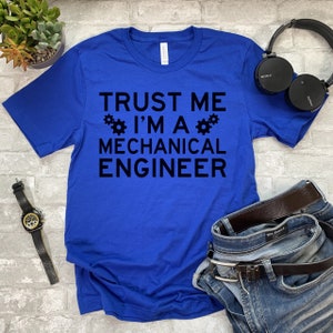 May include: A royal blue t-shirt with the text "TRUST ME I'M A MECHANICAL ENGINEER" in black. The text is surrounded by two small gear icons.