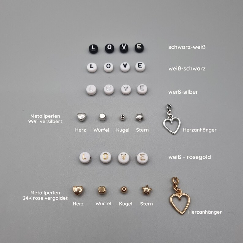 May include: A set of white, black and gold beads with the letters L, O, V and E. The beads are arranged in rows with different colour combinations. The beads are accompanied by small charms, including a heart, a cube, a sphere and a star. The text "Metallperlen 999&deg; versilbert" and "Metallperlen 24K rose vergoldet" is visible in the image. The text "schwarz-wei&szlig;", "wei&szlig;-schwarz", "wei&szlig;-silber", "wei&szlig; - rosegold" is also visible in the image.