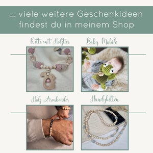 May include: A collection of handmade wooden jewellery and accessories. The image shows a pink and grey crocheted baby necklace with a wooden squirrel attached, a wooden baby mobile with a green crocheted turtle, a wooden bracelet, and a wooden phone strap.