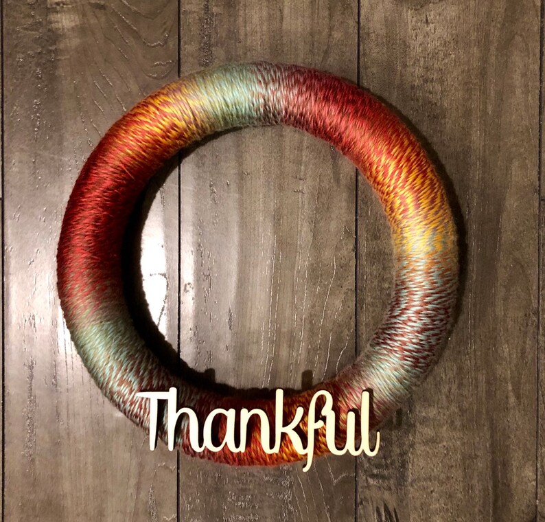 Super cute and fully customizable varied color yarn wreath Perfect for farmhouse decor and for year round decorating!