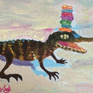 May include: An original painting of an alligator with a stack of colorful donuts on its head. The alligator is brown and green with a pink mouth and blue accents. The background is a pastel sky.