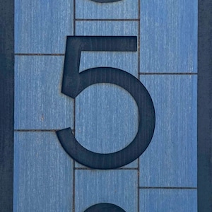 May include: A blue wooden sign with black numbers 358. The numbers are cut out of the wood and are raised.