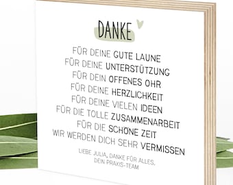 May include: A wooden block with a thank you message printed on it. The message says "DANKE" and includes a list of reasons for thanking someone, such as "for your good mood", "for your support", "for your open ear", and "for your many ideas". The message ends with "We will miss you very much".