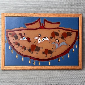 May include: A framed tile with a blue background and a brown and red design depicting a Native American scene. The scene shows figures on horseback, buffalo, and other animals.