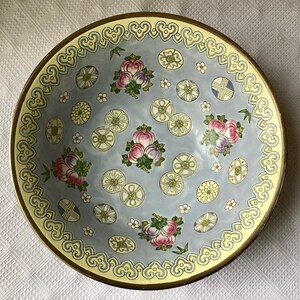May include: A blue and white porcelain bowl with a yellow rim and intricate floral and geometric patterns. The bowl has a delicate, hand-painted design.