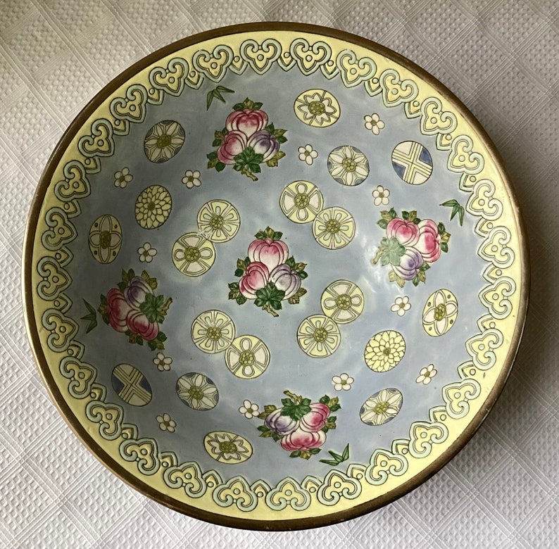 May include: A blue and white porcelain bowl with a yellow rim and intricate floral and geometric patterns. The bowl has a delicate, hand-painted design.