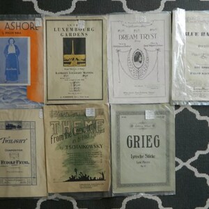 May include: A collection of vintage sheet music covers featuring titles like "All Ashore", "In the Luxembourg Gardens", "Dream Tryst", "Blue Hawaii", "Twilight", "Theme from the Concerto in B Flat Piano", and "Grieg Lyrische Stücke".