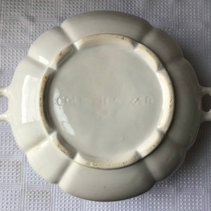 May include: White ceramic serving dish with a scalloped edge and two handles. The bottom of the dish has the text "Germany" printed on it.