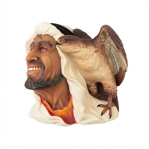 May include: A sculpted figurine depicting a person with a dark beard wearing a white head covering, with a brown and white falcon perched on the shoulder. The person has a smiling expression, and the falcon has detailed feathers and dark talons.