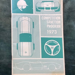 May include: A vintage pamphlet for the 1973 Corvette Competition Sanction Program. The pamphlet features a blue and white Corvette logo with the text "National Council Corvette Clubs, Inc."