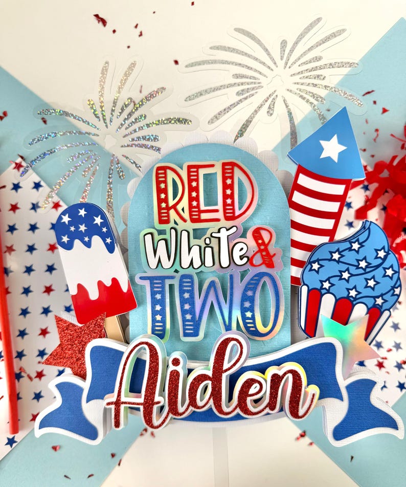 May include: Red, white, and blue cake topper with the words "Red White & Two Aiden" and a firework, ice cream cone, and cupcake design.