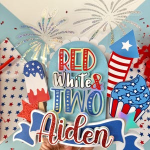 May include: Red, white, and blue cake topper with the words "Red White & Two Aiden" and a firework, cupcake, and popsicle design.