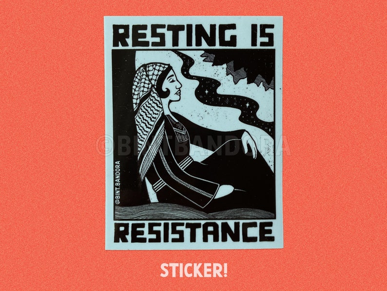 May include: A blue and white sticker with a black and white illustration of a woman wearing a headscarf. The text "RESTING IS RESISTANCE" is printed in black on the sticker. The text "STICKER!" is printed in black below the sticker.