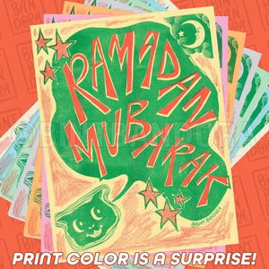 May include: A colorful greeting card with the text "Ramadan Mubarak" in red and green lettering. The card features a green cat with yellow eyes and a crescent moon in the top right corner. The card is surrounded by a stack of other cards with the text "Bint Ban Dora" repeated on each card.