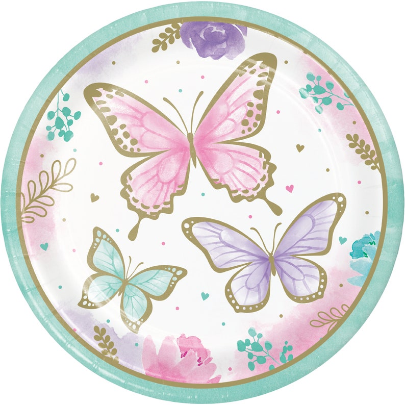 May include: A set of paper plates featuring a watercolor design of butterflies and flowers in shades of pink, purple, and green. The plates have a gold rim and are perfect for a spring or summer party.